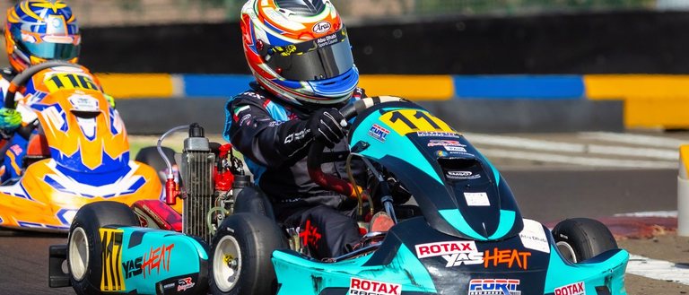 Karts three abreast into a braking zone